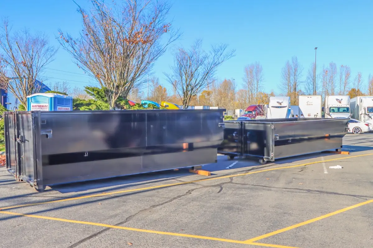 Professional dumpster rental service with roll-off container on residential driveway in Jarrell